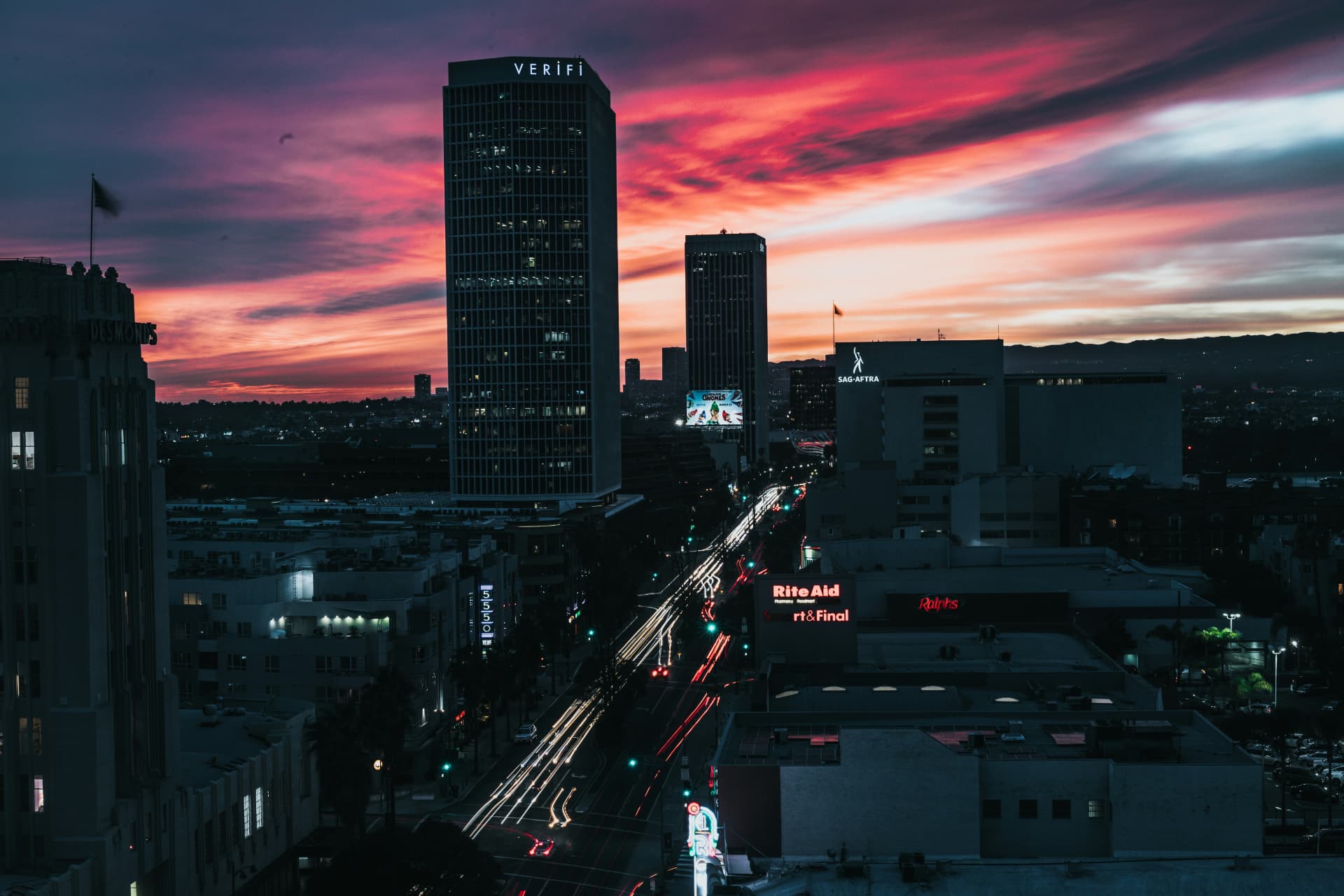Wilshire Boulevard towers and traffic light trails at sunset in Los Angeles