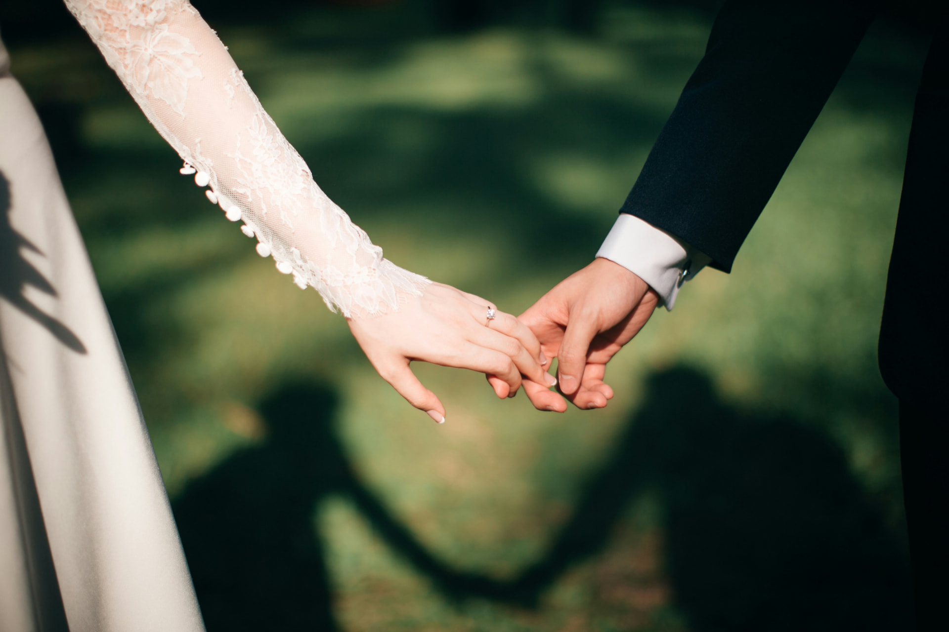 Bride and groom holding hands after arriving by private wedding car in Los Angeles