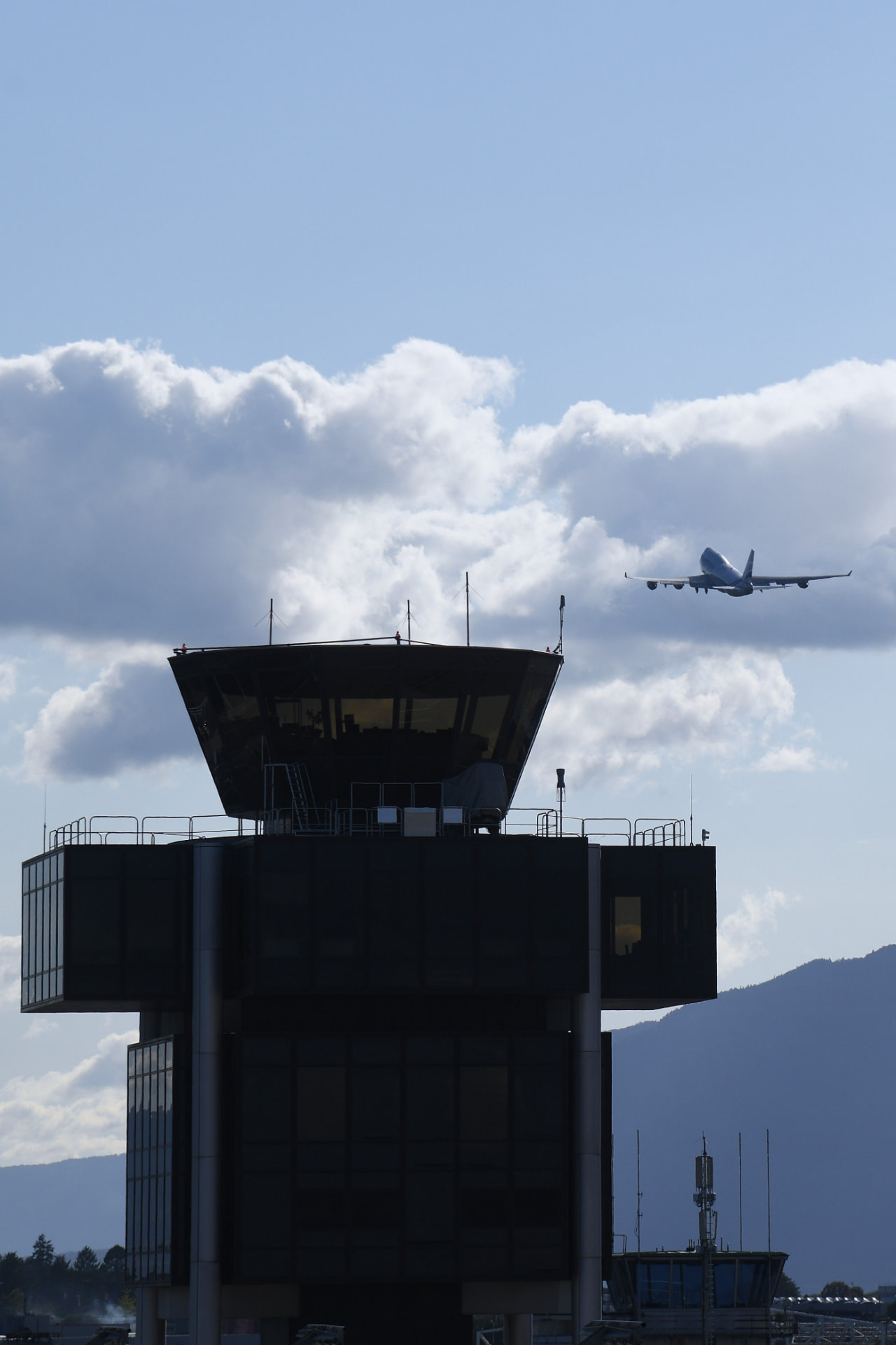 Aircraft approaching an airport control tower during a private Long Beach Airport transfer