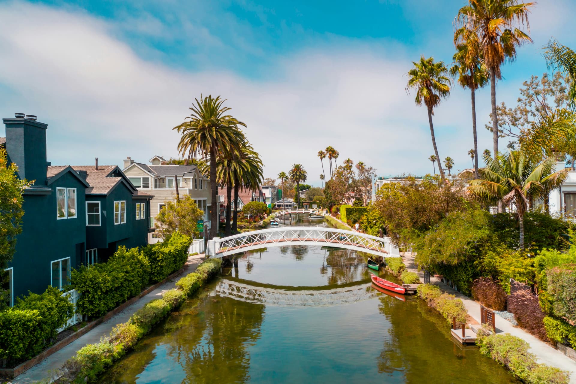 Venice Canals with houses, footbridges, and palm trees