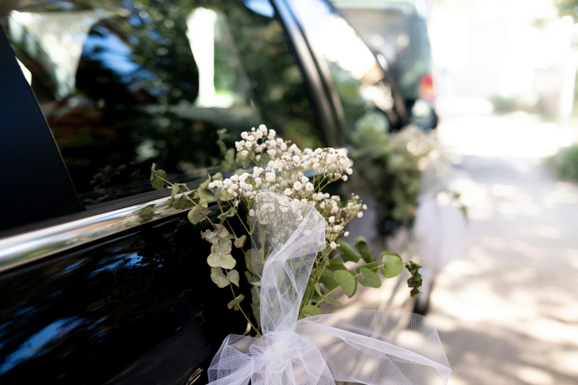 Black wedding car decorated with flowers for luxury wedding transport in Los Angeles