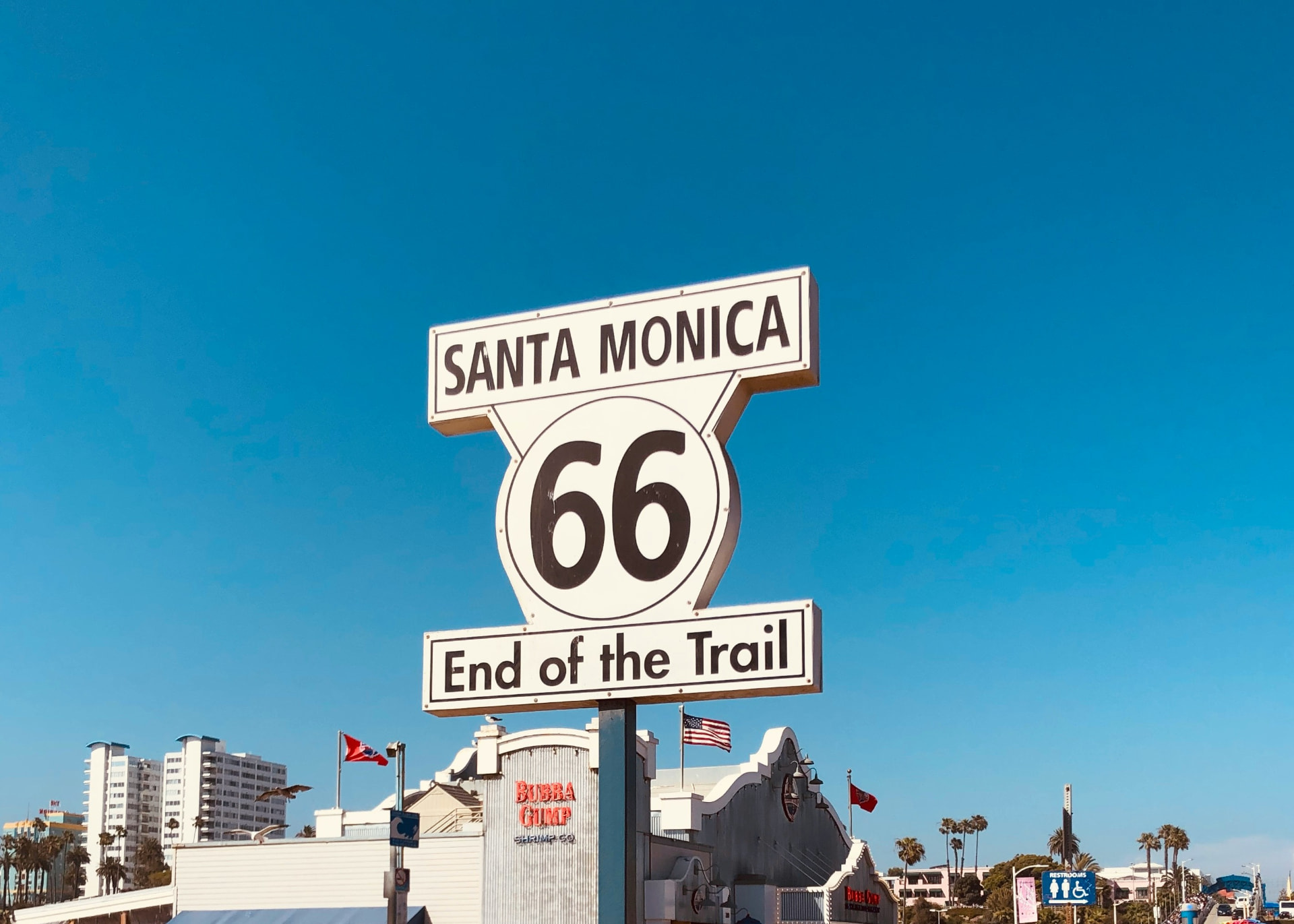 Santa Monica Route 66 End of the Trail sign against a blue sky